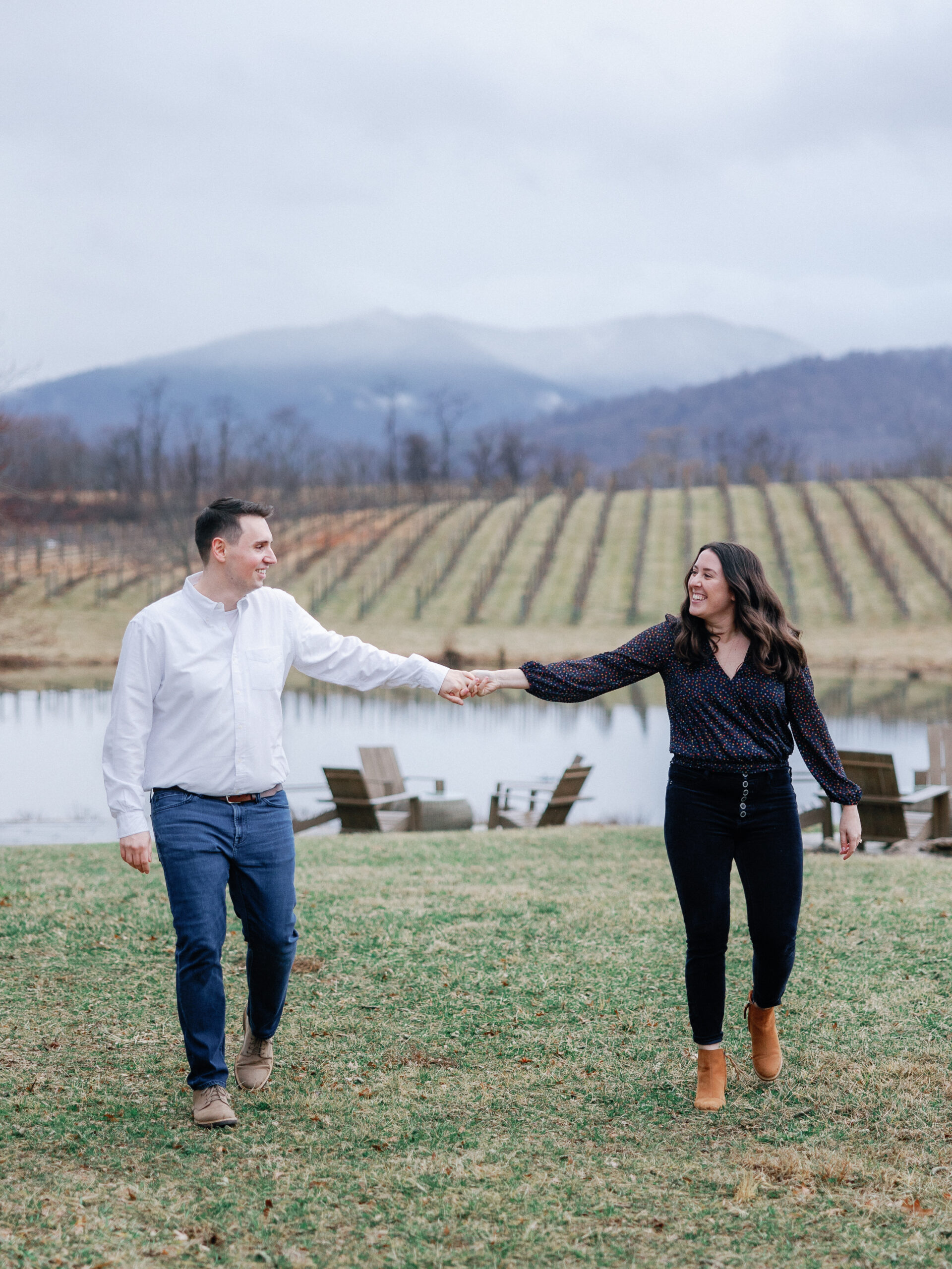 A couple holding hands in front of mountains in virginia